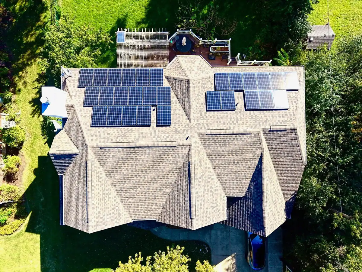 Overhead view of an architectural shingle roof with rooftop solar panels